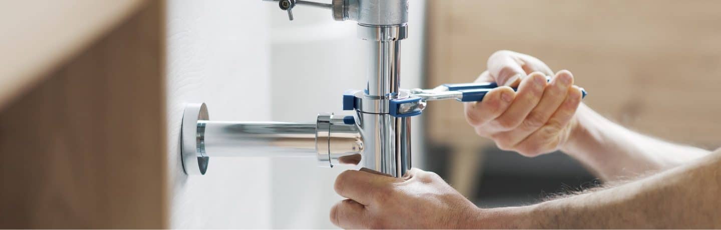 man screwing faucet