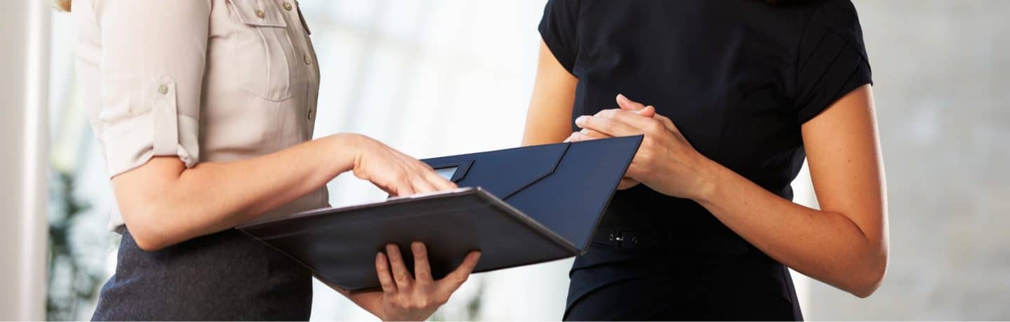 business women reviewing paperwork