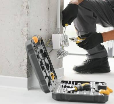 Electrician working on power outlet