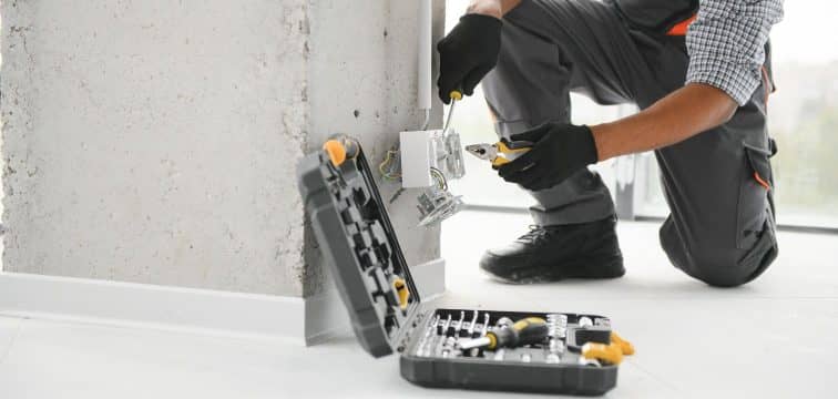 Electrician working on power outlet