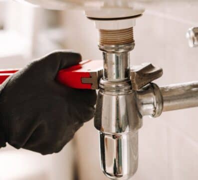 plumber working on bathroom sink