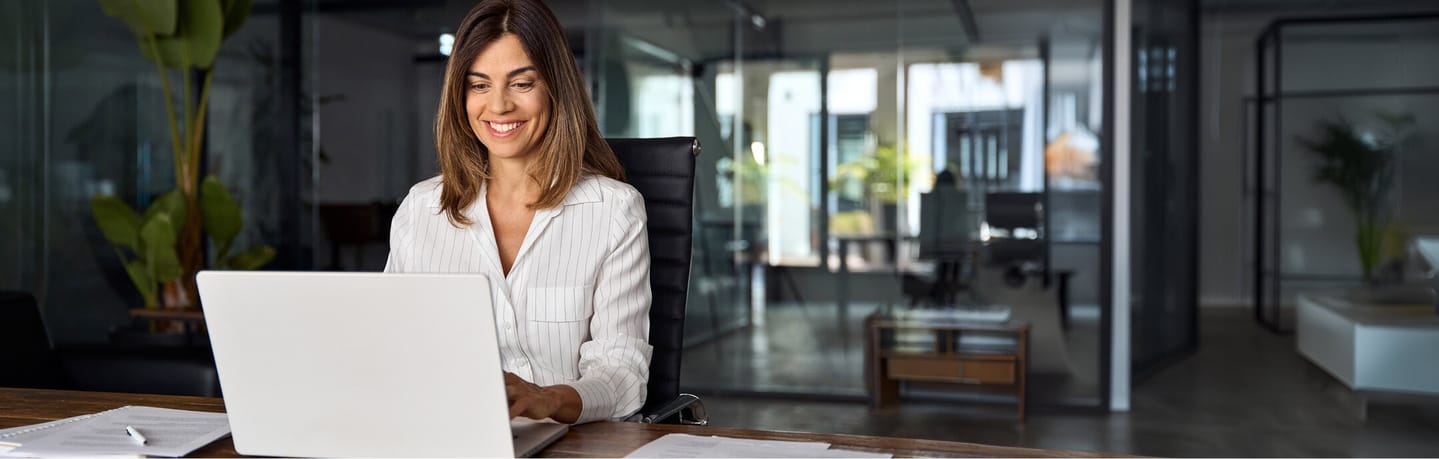 business woman smiling at laptop