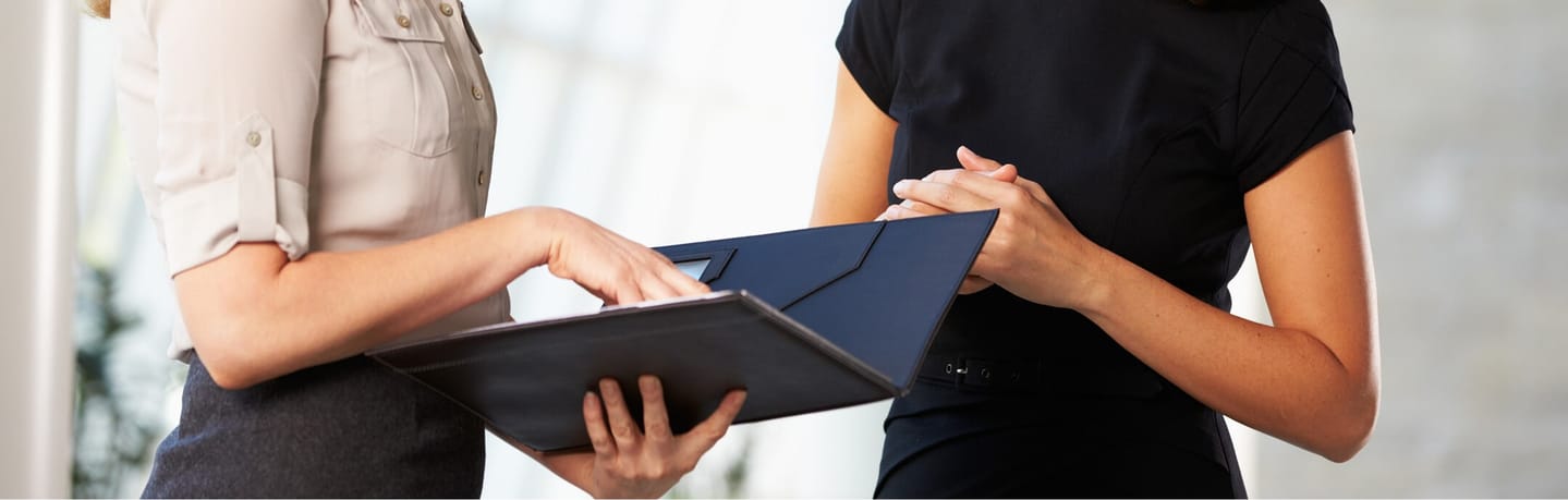 business women reviewing paperwork