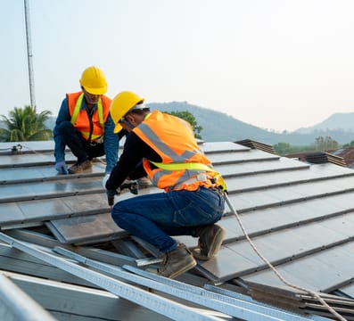 Two men repairing a roof