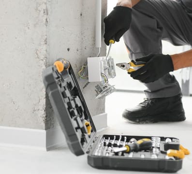 Electrician working on power outlet