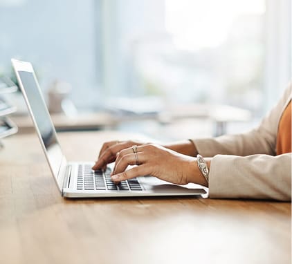 business woman typing on laptop