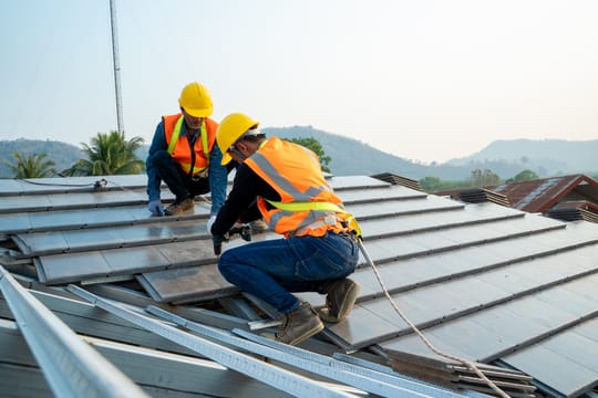 Two men repairing a roof